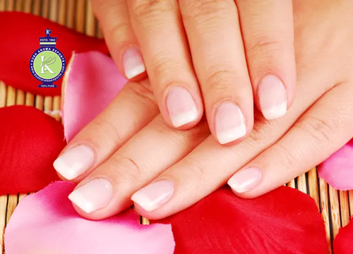 Healthy natural nails with smooth finish placed on rose petals representing essential oil for nails care and nail strengthening