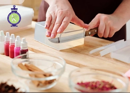 Best essential oils for soap making displayed with handmade soap bars, dried herbs, and natural botanical ingredients.