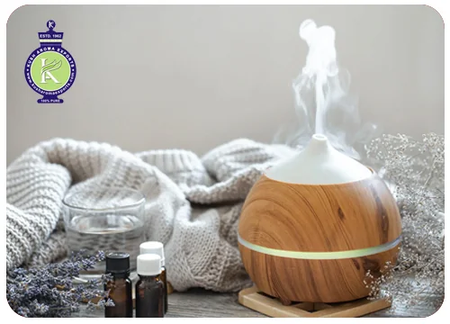 Essential oils and their uses: wooden aroma diffuser with essential oil bottles and lavender